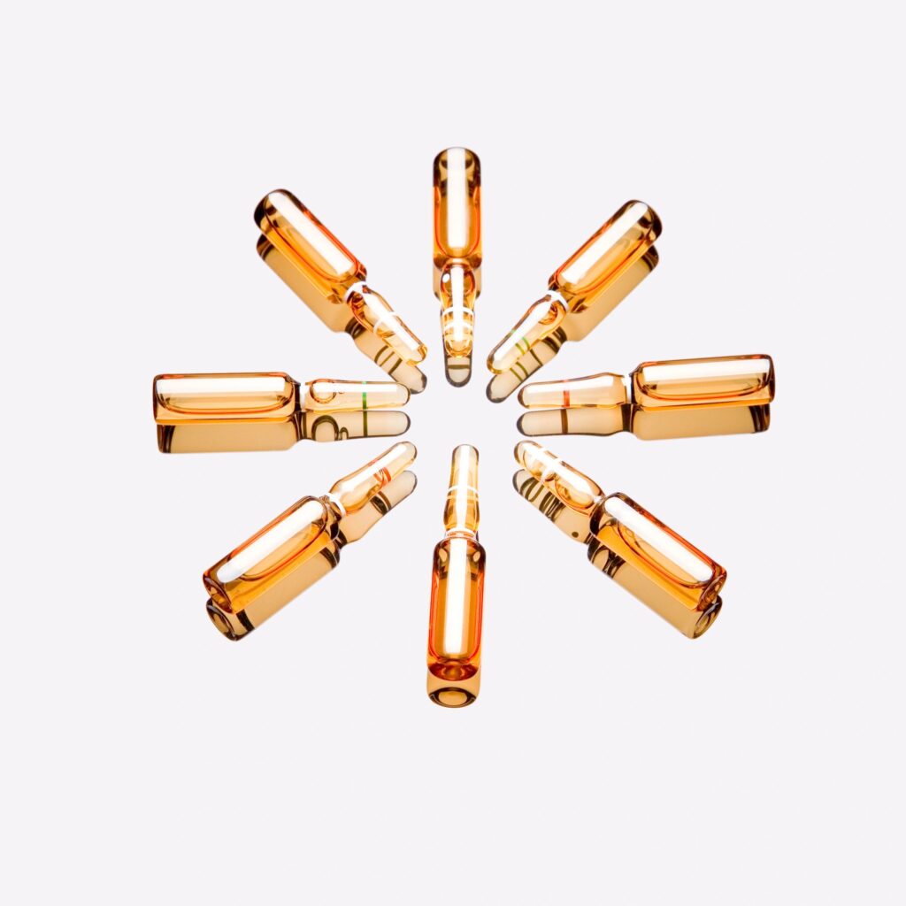 Clinical-style group of clear research vials on a clean white background
