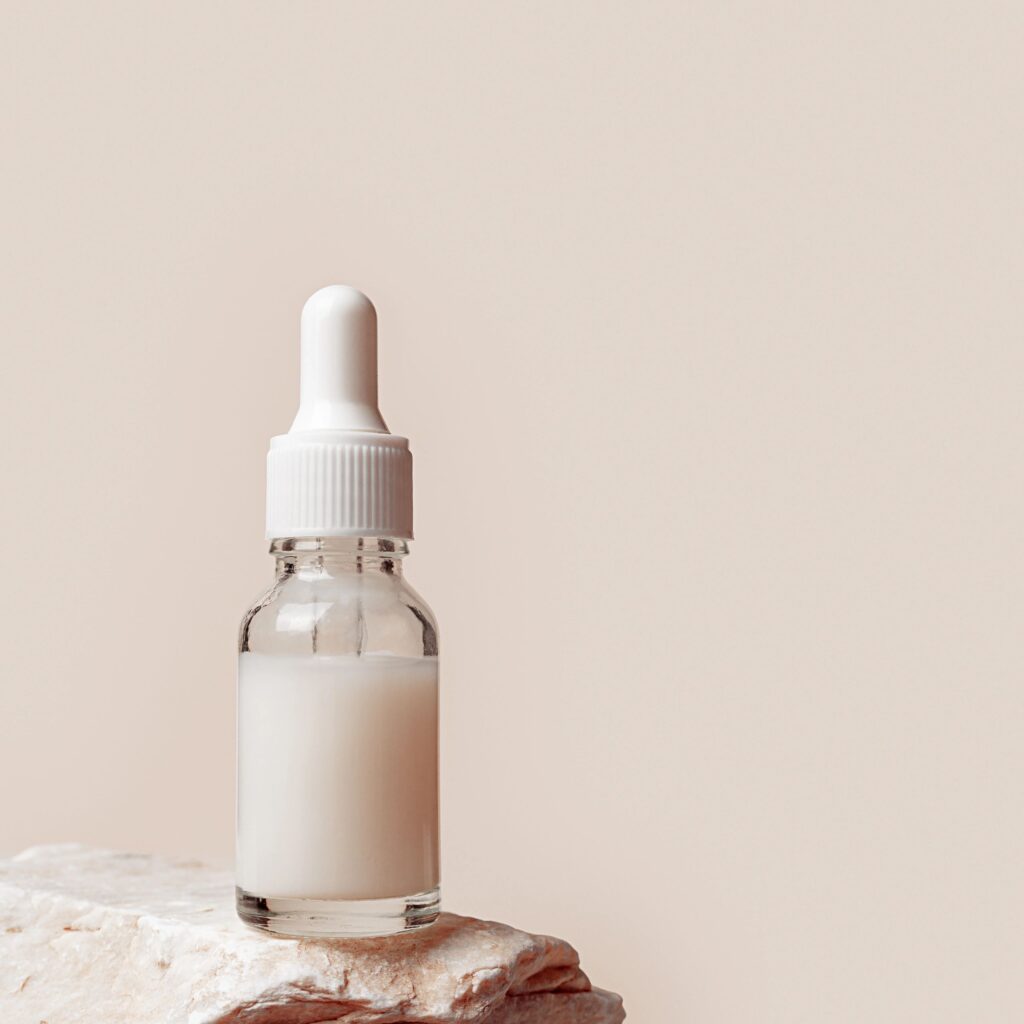 Clinical dropper bottle on neutral background for GHK-Cu product aesthetic