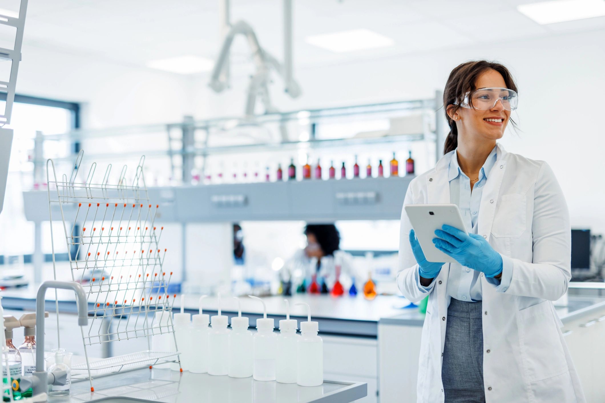 Scientist using a tablet for quality control documentation in a lab